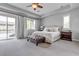 Main bedroom with tray ceiling, sliding glass doors to the pool, and ensuite bathroom at 8717 Purple Wisteria St, Las Vegas, NV 89131