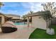 Relaxing backyard featuring a pool, an outdoor daybed, and a covered patio for entertaining at 9475 Windham Heights Ct, Las Vegas, NV 89139