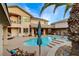 Expansive backyard with a swimming pool, patio, and lush landscaping, creating an ideal retreat at 9475 Windham Heights Ct, Las Vegas, NV 89139