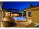 Backyard oasis with luminous pool and covered patio for entertainment at 9475 Windham Heights Ct, Las Vegas, NV 89139