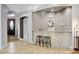 Elegant bar area with tile flooring, granite countertop, and contemporary lighting at 9475 Windham Heights Ct, Las Vegas, NV 89139
