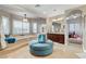 Bright bathroom featuring a soaking tub, plush seating, and a vanity with cherry-wood cabinetry at 9475 Windham Heights Ct, Las Vegas, NV 89139