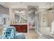 A luxurious bathroom with a glass-enclosed shower, dual vanities, and an adjacent exercise area at 9475 Windham Heights Ct, Las Vegas, NV 89139