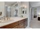 Bathroom with a double sink vanity, dark wood cabinets, and a view of other rooms at 9475 Windham Heights Ct, Las Vegas, NV 89139