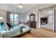 Well-lit bedroom with wood floors, a ceiling fan, and access to the upper level at 9475 Windham Heights Ct, Las Vegas, NV 89139