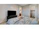 Comfortable bedroom with a TV, decorative bedding, and an adjoining bathroom and closet at 9475 Windham Heights Ct, Las Vegas, NV 89139