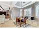 Inviting dining area features a built-in bench, a modern pendant light, and views of the fireplace at 9475 Windham Heights Ct, Las Vegas, NV 89139