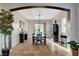 Dining room with wood floors, modern light fixture, and archway into the living area at 9475 Windham Heights Ct, Las Vegas, NV 89139