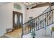 Grand entrance with double doors, mosaic tile, and curved staircase with iron railing at 9475 Windham Heights Ct, Las Vegas, NV 89139