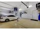 Spacious three car garage, with ample storage and a white car parked inside at 9475 Windham Heights Ct, Las Vegas, NV 89139
