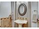 Stylish powder room features a pedestal sink with decorative mirror and tile backsplash at 9475 Windham Heights Ct, Las Vegas, NV 89139