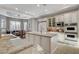Bright kitchen features granite countertops, large island, stainless appliances, and custom white cabinetry at 9475 Windham Heights Ct, Las Vegas, NV 89139
