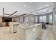 Spacious kitchen featuring stone countertops, tile floors, and open layout to the living area at 9475 Windham Heights Ct, Las Vegas, NV 89139