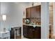 Kitchenette featuring dark cabinets, a beverage fridge, and a subway tile backsplash at 9475 Windham Heights Ct, Las Vegas, NV 89139