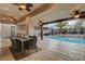 Outdoor living with a covered patio, a dining table, and a view of the pool and lush landscaping at 9475 Windham Heights Ct, Las Vegas, NV 89139