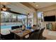 Covered patio area featuring a dining table and chairs overlooking the pool and backyard at 9475 Windham Heights Ct, Las Vegas, NV 89139