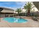 Inviting backyard pool with a baja step, water feature, and plenty of room for lounging in the sun at 9475 Windham Heights Ct, Las Vegas, NV 89139