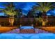Inviting pool and spa area surrounded by lush landscaping and mature palm trees at 9475 Windham Heights Ct, Las Vegas, NV 89139