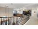 Elegant staircase featuring dark metal railings leads to a cozy upstairs loft area with custom built-ins at 9475 Windham Heights Ct, Las Vegas, NV 89139