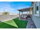 Backyard features a covered patio, artificial turf, and privacy fence at 4735 Agave Cactus St, North Las Vegas, NV 89031