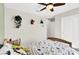 Cozy bedroom with a ceiling fan, white closet doors, and decorative plants on shelves at 4735 Agave Cactus St, North Las Vegas, NV 89031