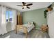 Bright bedroom with a ceiling fan, charming decor, a large window, and natural light at 4735 Agave Cactus St, North Las Vegas, NV 89031