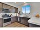 Gourmet kitchen with stainless steel appliances, light countertops, and sleek cabinetry at 4735 Agave Cactus St, North Las Vegas, NV 89031