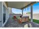 Covered patio with brick pavers and comfortable seating for outdoor enjoyment at 4735 Agave Cactus St, North Las Vegas, NV 89031