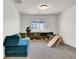 Spacious playroom with a modular sofa, wooden climbing triangle, and built-in shelving at 4735 Agave Cactus St, North Las Vegas, NV 89031