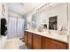 Bathroom featuring double sinks, vanity, light fixtures and decorative shower curtain at 10086 Aspen Rose St # 101, Las Vegas, NV 89183