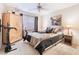 Bedroom with a large bed, decorative pillows, side table, lamp and workout equipment at 10086 Aspen Rose St # 101, Las Vegas, NV 89183