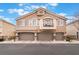 Inviting townhome with a private balcony and three-car garage spaces, complemented by manicured landscaping at 10086 Aspen Rose St # 101, Las Vegas, NV 89183