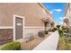 Exterior view featuring an entry door, walkway, and landscape elements like bushes and trees at 10086 Aspen Rose St # 101, Las Vegas, NV 89183