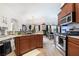 Open kitchen featuring granite counters, stainless steel appliances, and an island with sink at 10086 Aspen Rose St # 101, Las Vegas, NV 89183