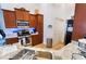 Well-lit kitchen with a stainless steel sink, appliances, granite countertops, and ample cabinet storage at 10086 Aspen Rose St # 101, Las Vegas, NV 89183