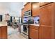 Kitchen features wooden cabinets, stainless steel appliances, granite countertops, and seamless access to the living area at 10086 Aspen Rose St # 101, Las Vegas, NV 89183