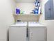 Laundry room features white washer and dryer with shelving and storage at 10086 Aspen Rose St # 101, Las Vegas, NV 89183