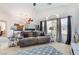 Bright living room with a comfortable sofa, large window, and stylish decor creating an inviting space at 10086 Aspen Rose St # 101, Las Vegas, NV 89183