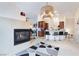 Bright living area flows into a kitchen and bar area, enhanced by a stylish fireplace and modern lighting at 10086 Aspen Rose St # 101, Las Vegas, NV 89183