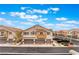 Street view of attractive townhomes with private balconies and attached garages in a lovely community at 10086 Aspen Rose St # 101, Las Vegas, NV 89183