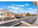 Street view shows the community featuring residential homes with garages and balconies under a cloudy sky at 10086 Aspen Rose St # 101, Las Vegas, NV 89183