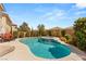 Backyard with inground pool and spa with outdoor dining and seating area at 10892 Royal Highlands St, Las Vegas, NV 89141