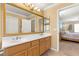 Bathroom featuring a double vanity and a door leading to the bedroom at 10892 Royal Highlands St, Las Vegas, NV 89141