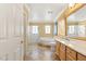 Bright bathroom showcasing a bathtub, shower, double vanity and tile floor at 10892 Royal Highlands St, Las Vegas, NV 89141
