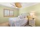 Bright bedroom featuring a bed, nightstand, and natural lighting at 10892 Royal Highlands St, Las Vegas, NV 89141