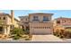 Two-story home featuring desert landscaping, a tile roof, and an attached two-car garage at 10892 Royal Highlands St, Las Vegas, NV 89141