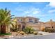 A two-story home boasting desert landscaping, a tile roof, and a two-car garage at 10892 Royal Highlands St, Las Vegas, NV 89141