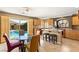 A bright kitchen and breakfast nook with tile floors and access to a private pool at 10892 Royal Highlands St, Las Vegas, NV 89141
