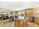 Open floor plan features a kitchen with granite countertops that flows to a living area with a fireplace and access to the yard at 10892 Royal Highlands St, Las Vegas, NV 89141