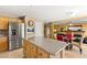 Kitchen with granite countertops and stainless appliances opens to the living area with a fireplace and dining area at 10892 Royal Highlands St, Las Vegas, NV 89141